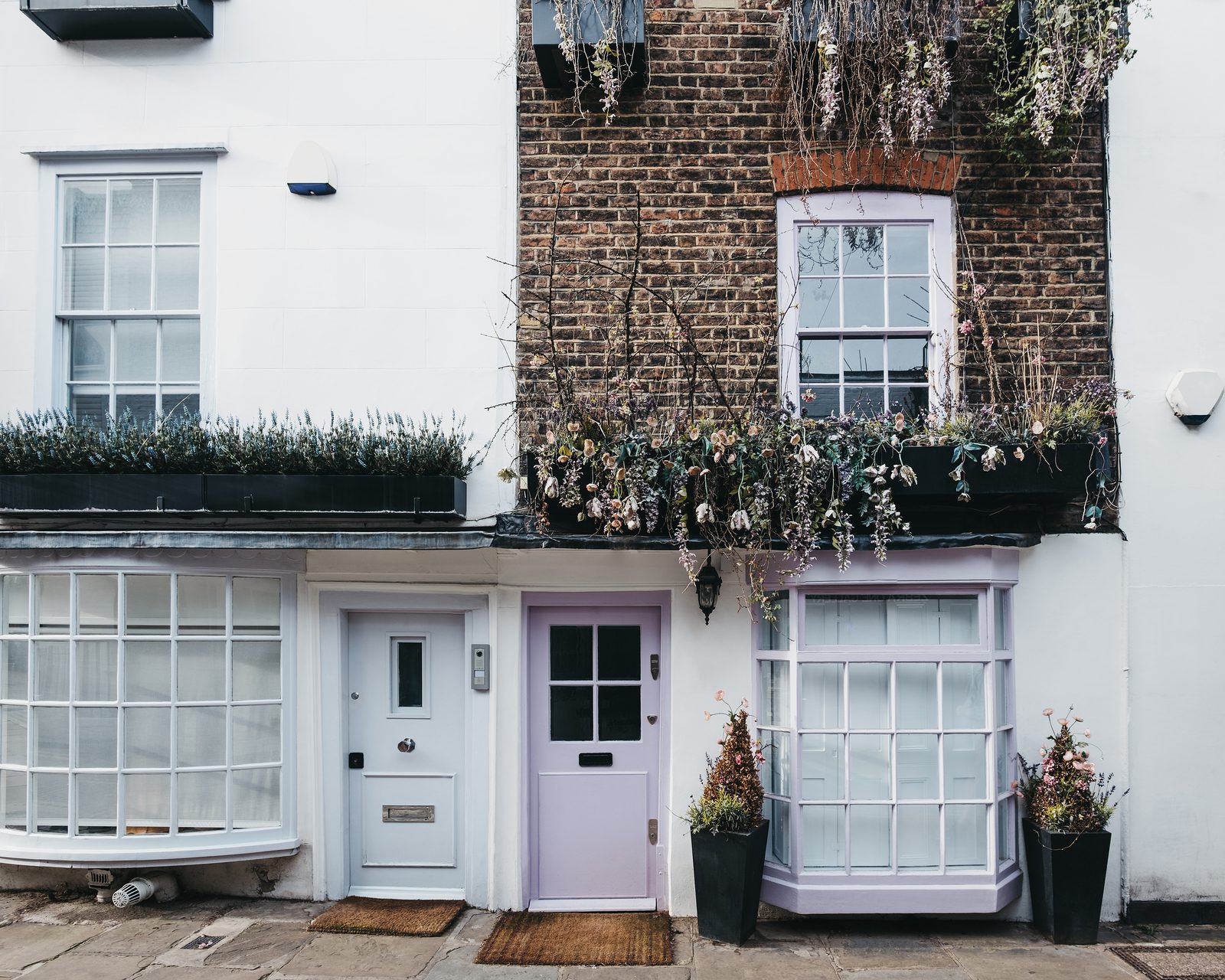 Pastel pink door on a facade of traditional English house in London, UK.