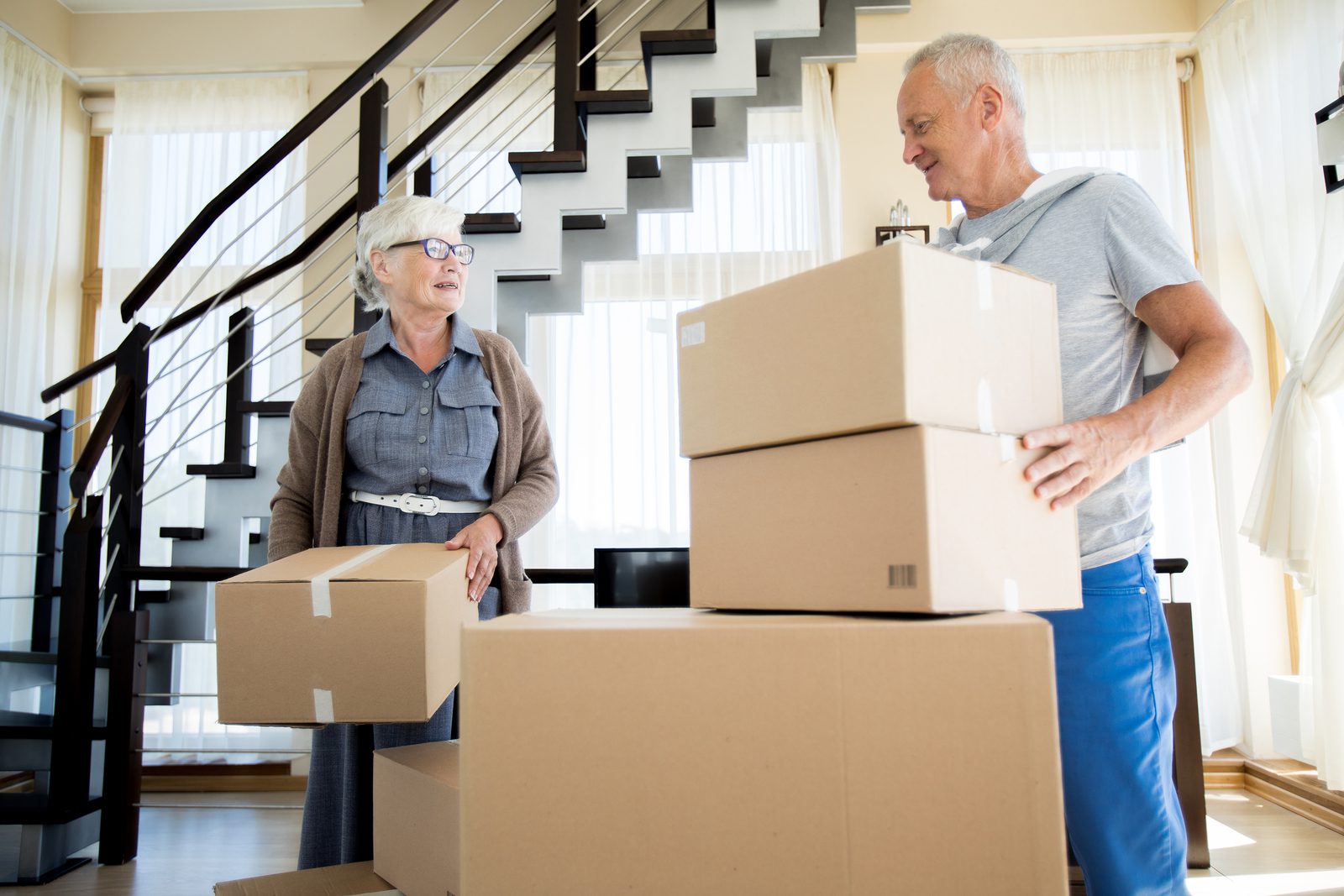 happy senior couple moving into their new house