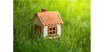 bigstock-small-wooden-house-model-on-t-3715447841