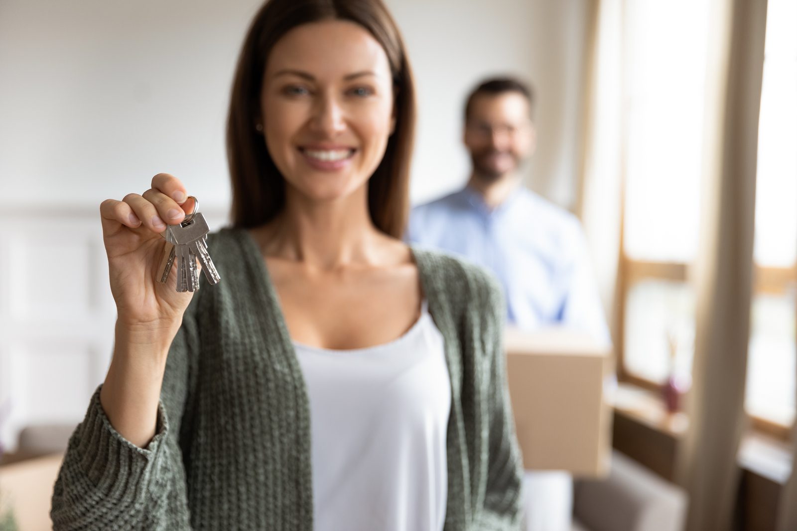 young woman showing house keys