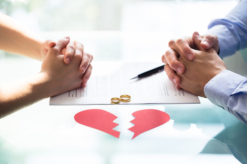 bigstock-couple-s-hand-on-divorce-paper-2454371022