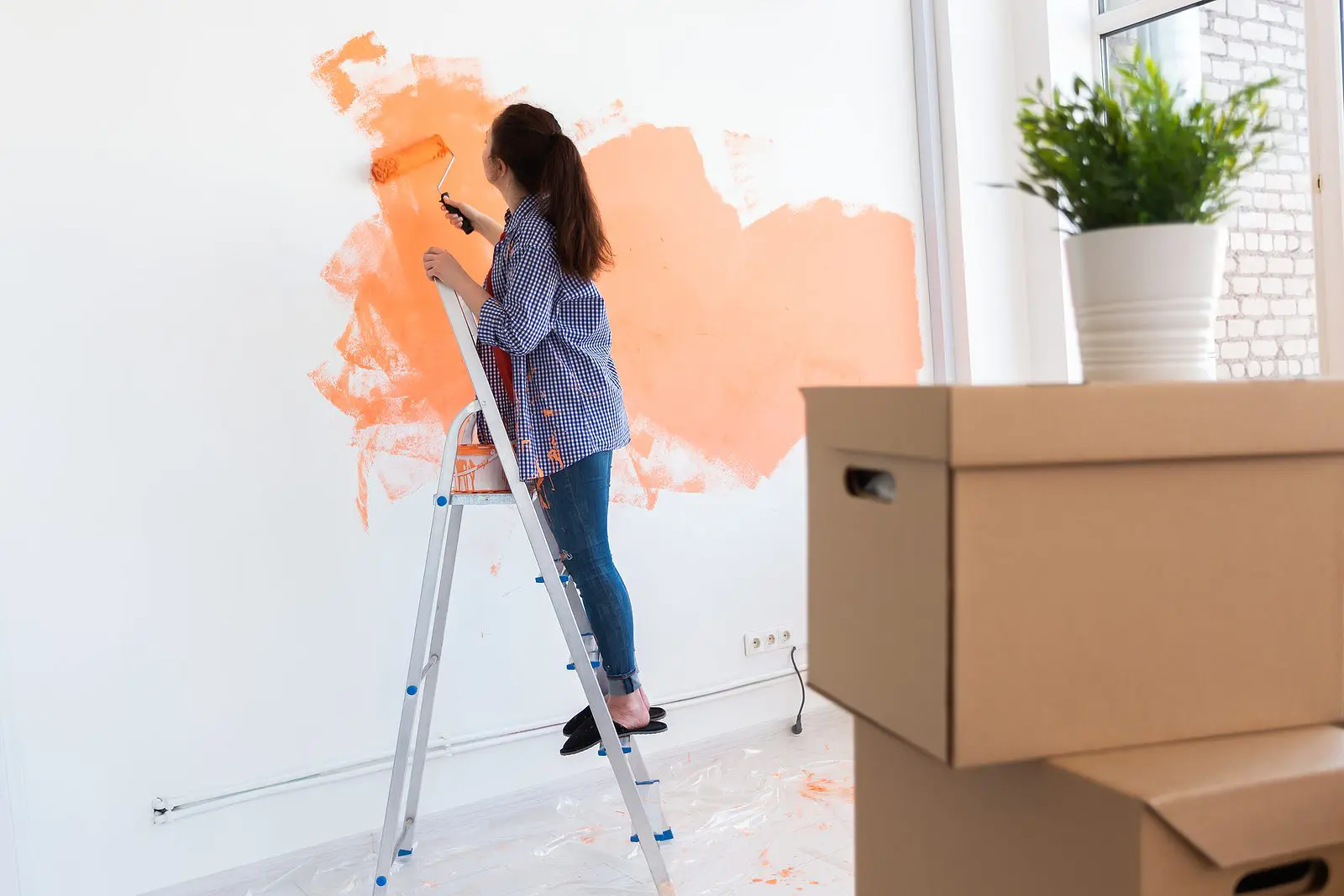 bigstock-happy-smiling-woman-painting-i-374944072